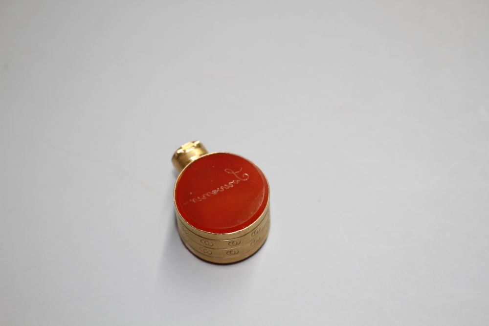 A small 19th century engraved gold and carnelian set moon shaped scent flask, 29mm.